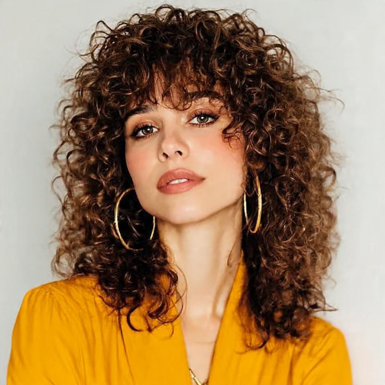 curtain bangs with tight curls hairstyle