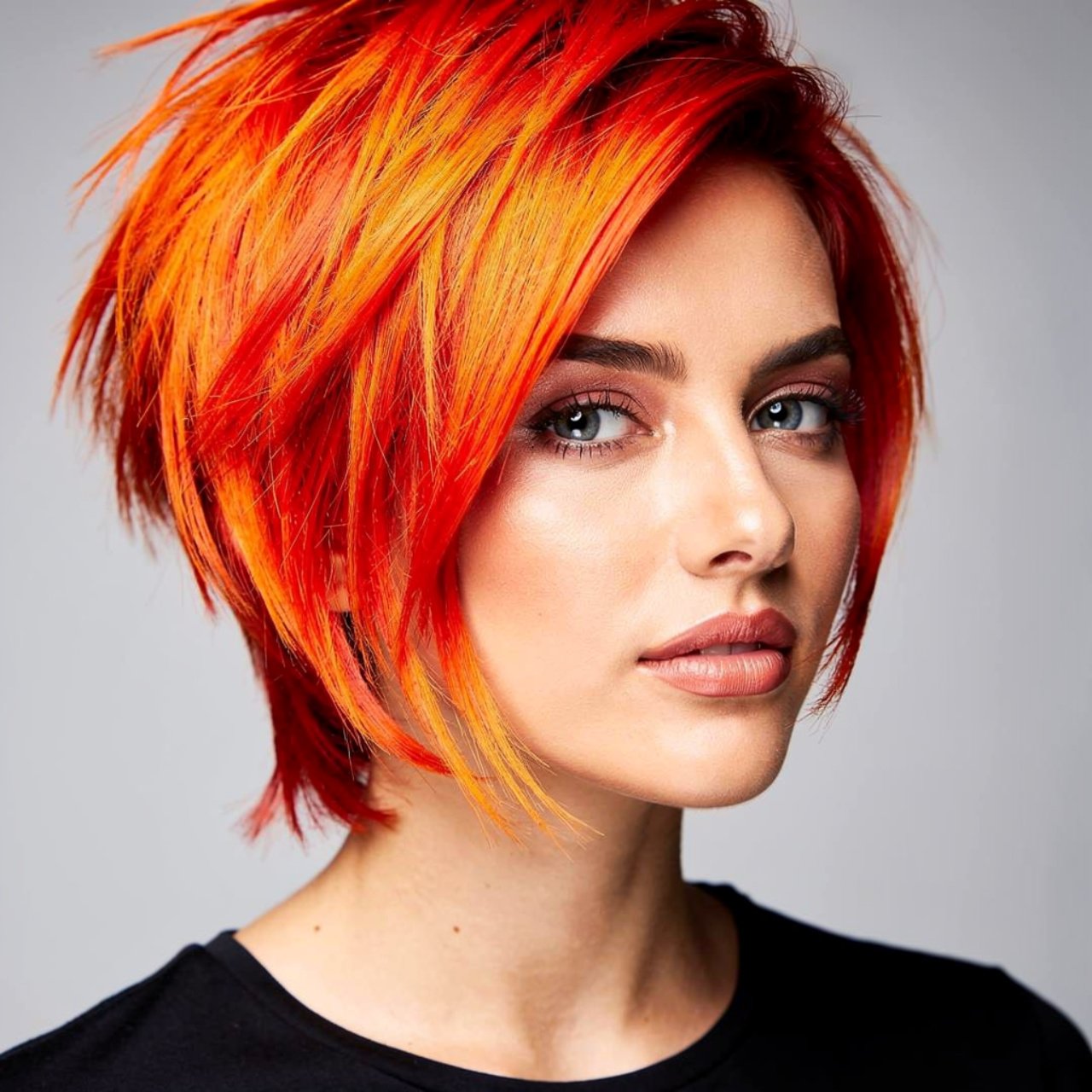portrait of a person with fiery orange and red ble