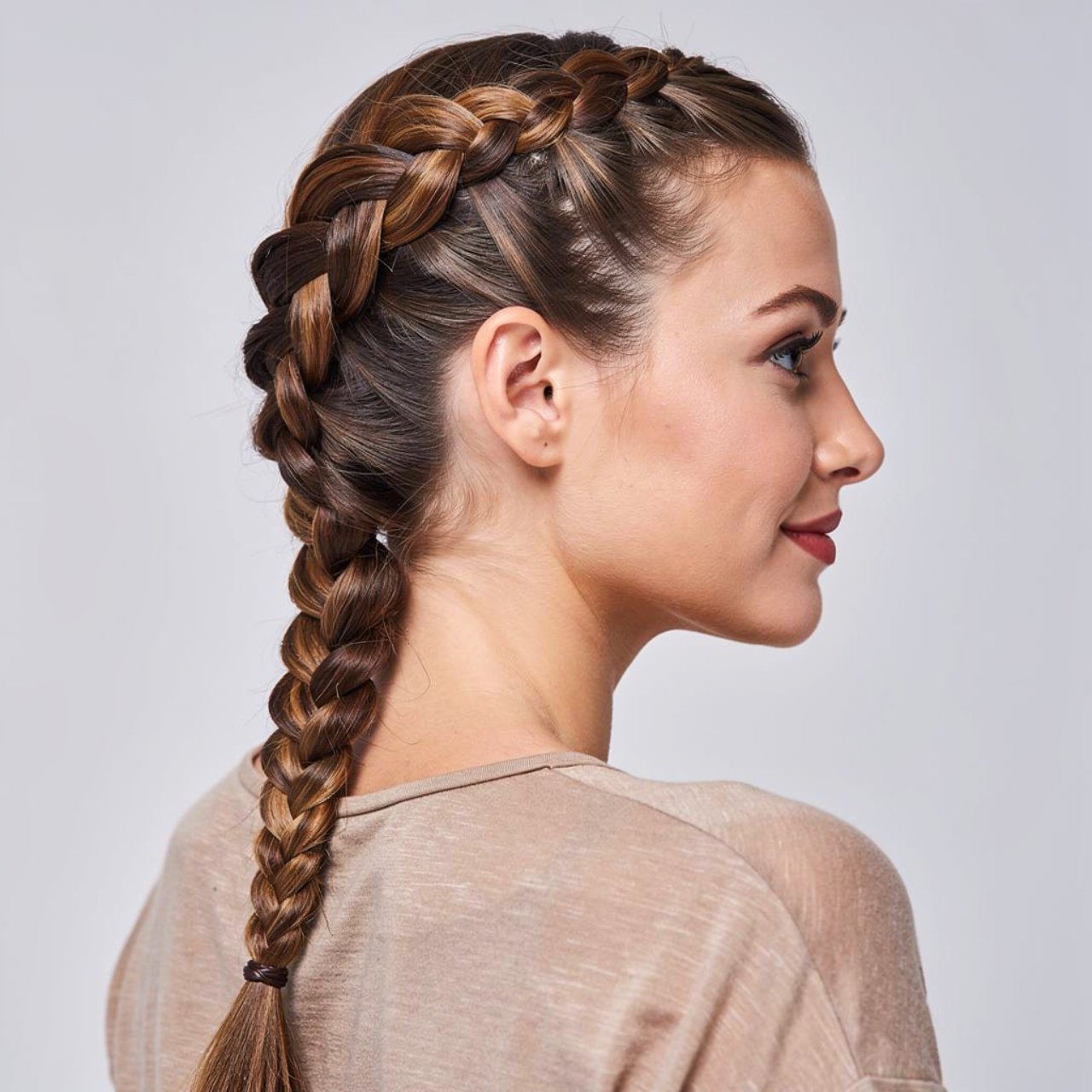 side braid hairstyle on a woman wearing a full nec