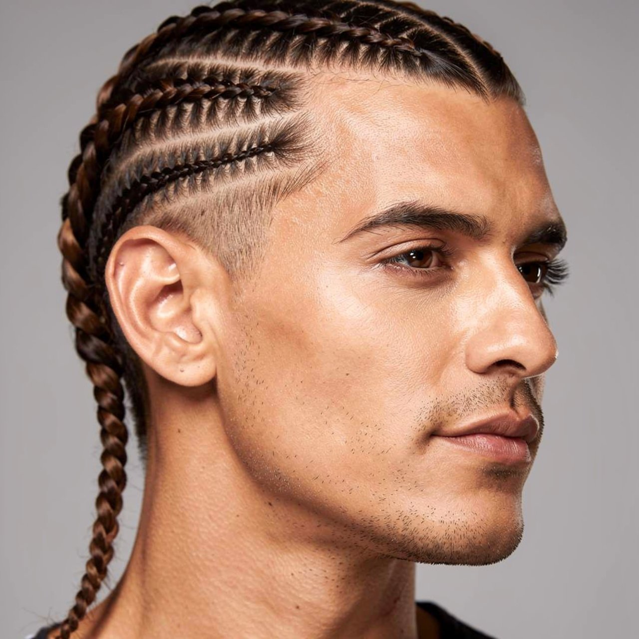 single photo of a man with side braids hairstyle c