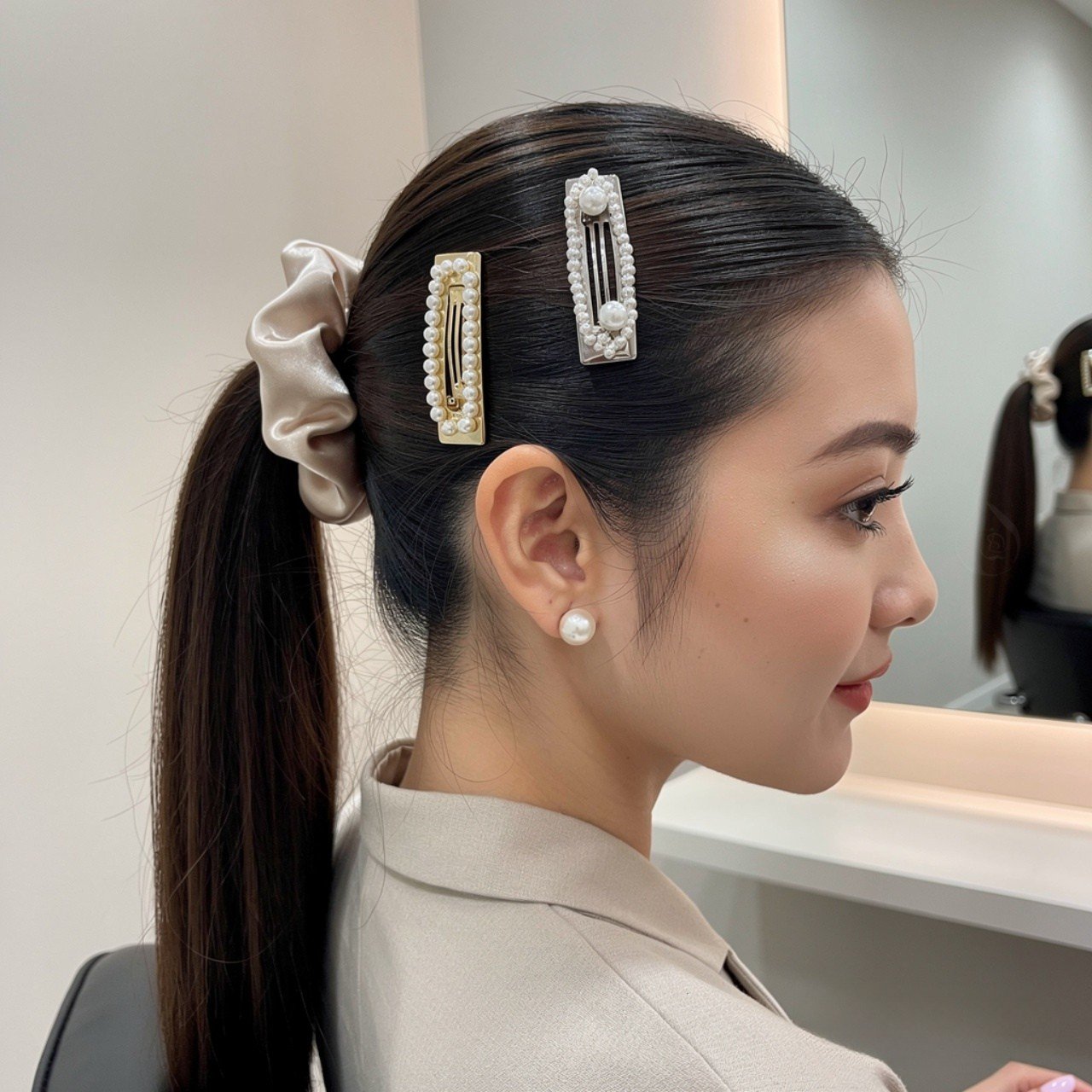 single portrait of a woman with a sleek ponytail h