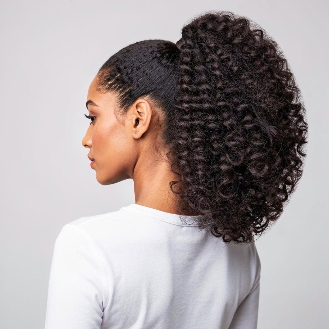 voluminous curly ponytail hairstyle square portrai