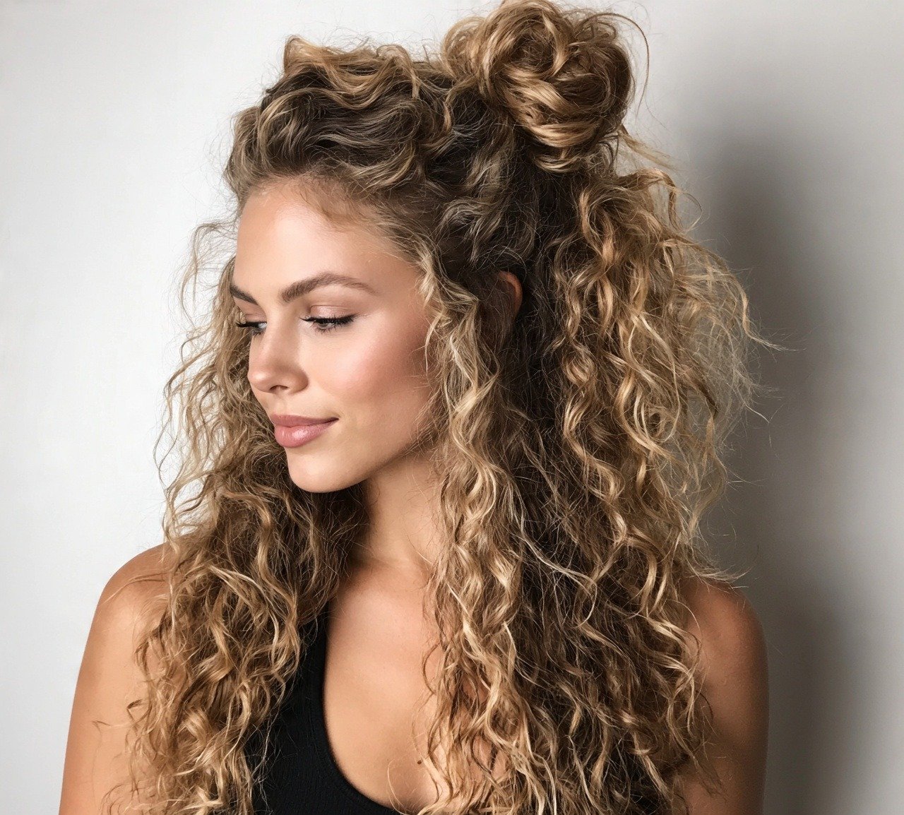 15 Trending Curly Bun Hairstyles That Instantly Elevate Your Style 6 5. Half Up Curly Bun Hairstyles