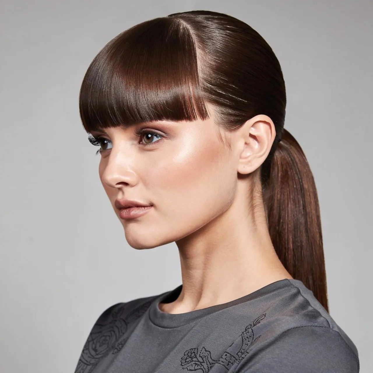 sleek ponytail hairstyle with blunt bangs square p