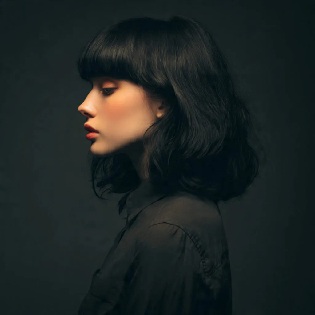 16 Wolf Cut with Bangs: Trendy Styles & Ideas 13 wolf cut hairstyle with blunt bangs single portrai