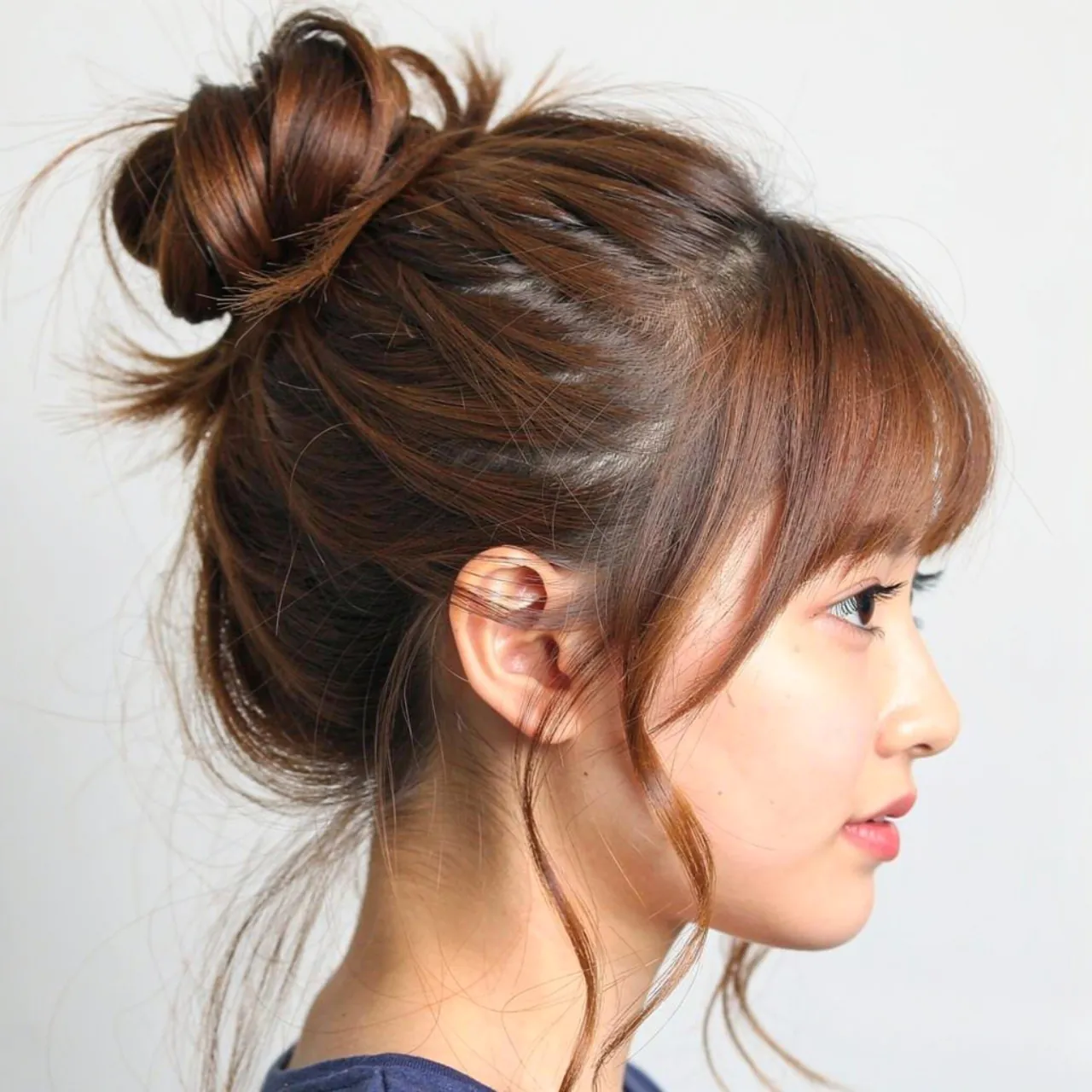 messy bun school hairstyle for medium hair single