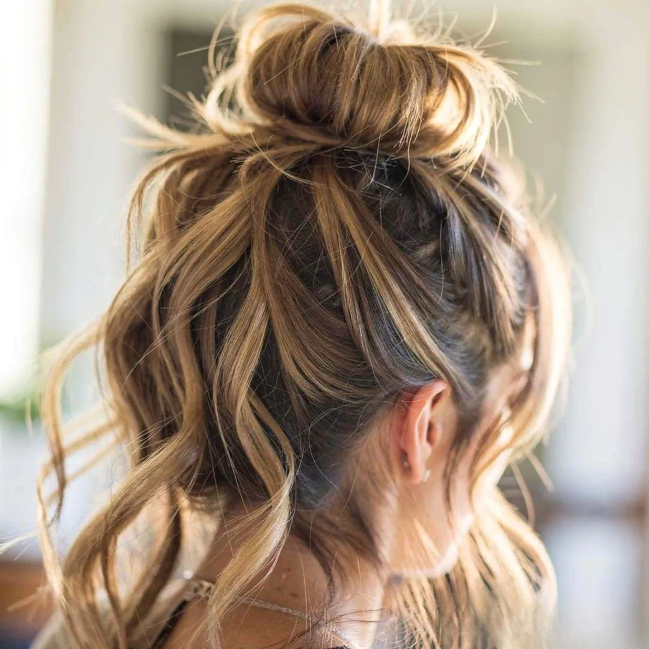 single photo of a messy top knot with soft layers